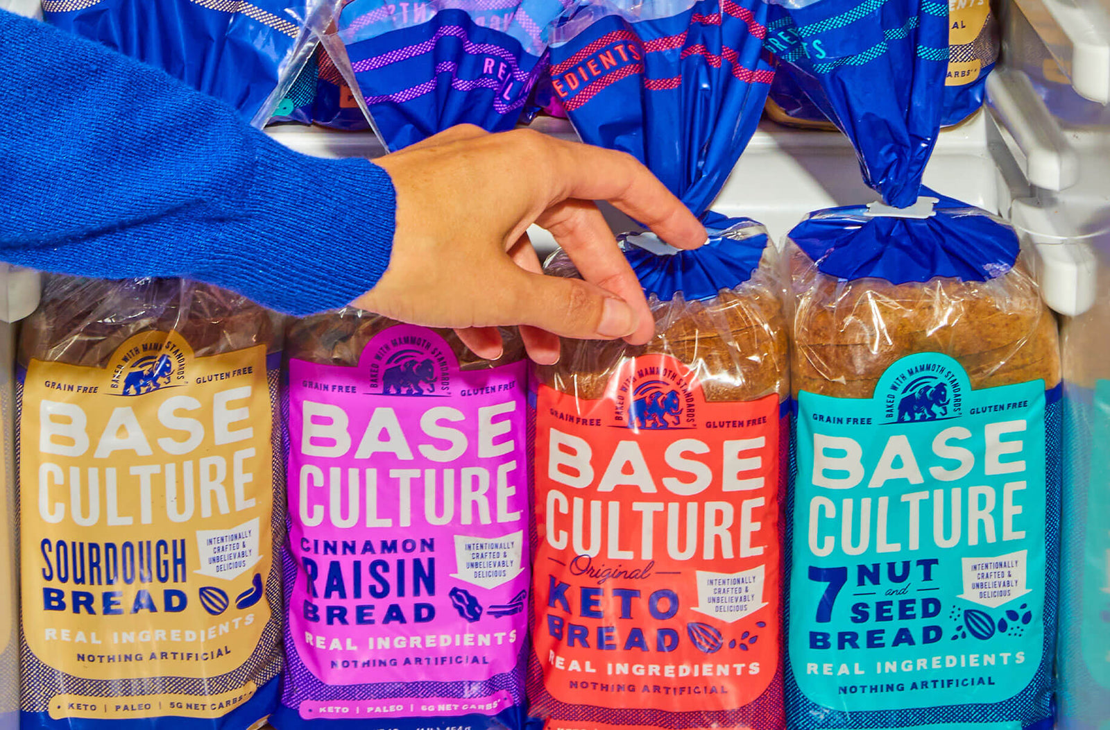 Hand Reaching for Base Culture Keto Bread