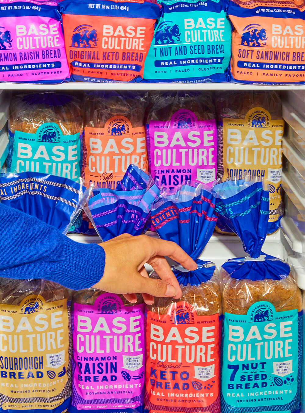 Hand Reaching for Base Culture Keto Bread 